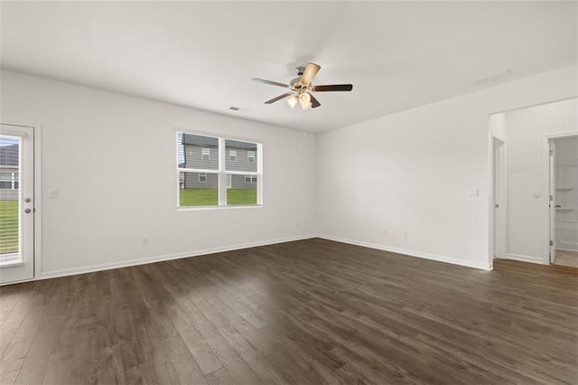 empty room with dark wood-type flooring and ceiling fan