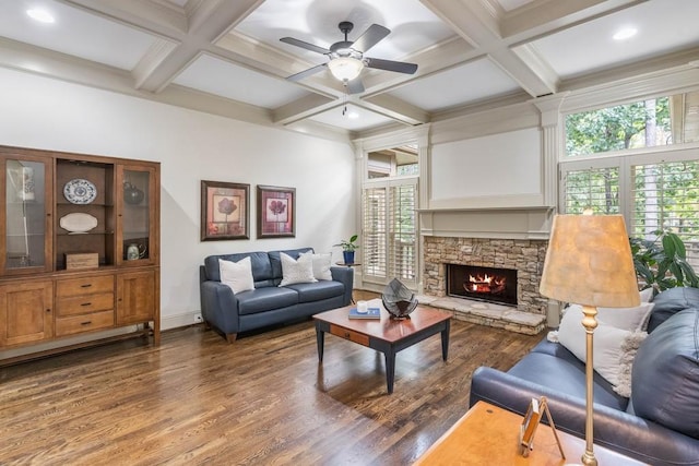 living room with coffered ceiling, ceiling fan, a fireplace, and dark hardwood / wood-style floors