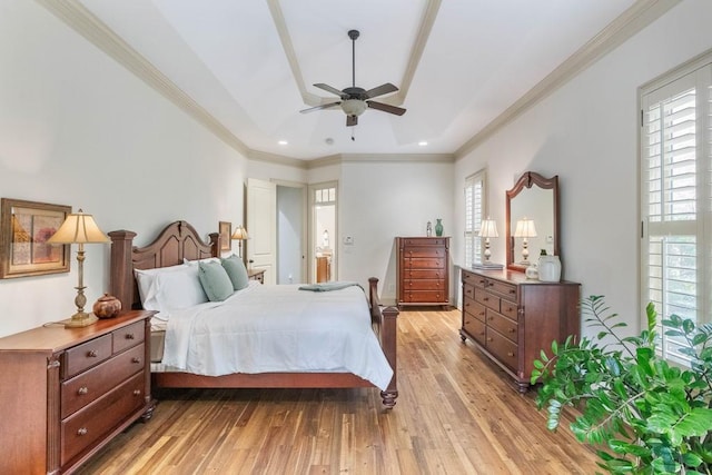 bedroom featuring ceiling fan, crown molding, multiple windows, and light wood-type flooring