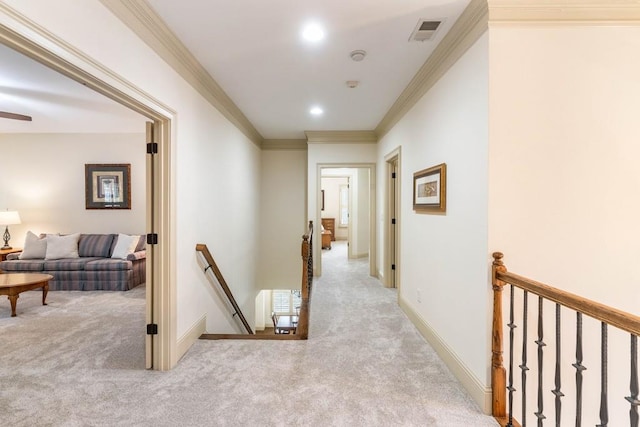 hall featuring crown molding and light colored carpet