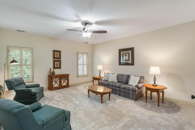 living room with light carpet, a healthy amount of sunlight, and ceiling fan