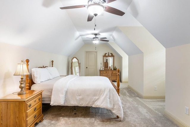 bedroom with vaulted ceiling, light colored carpet, and ceiling fan