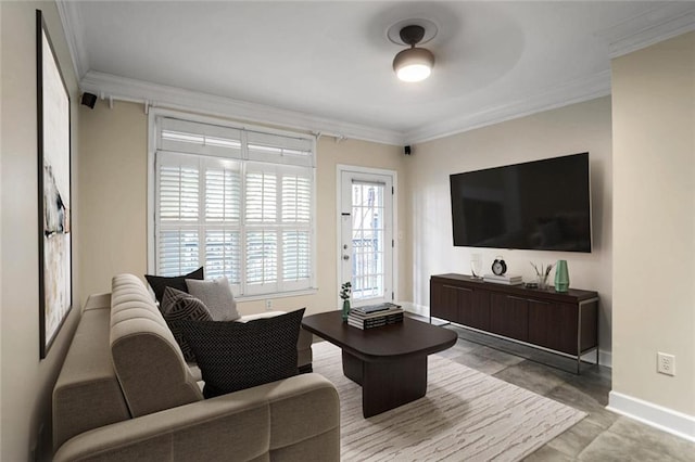 living area with baseboards and crown molding