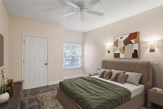 bedroom featuring baseboards, a textured ceiling, and a ceiling fan