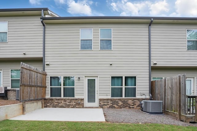 1360 Sugar Glen Ct, Lawrenceville, GA 30044 - back of house featuring cooling unit, a patio area, and brick siding