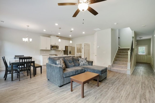 1360 Sugar Glen Ct, Lawrenceville, GA 30044 - living room with light wood-style floors, ceiling fan, stairway, recessed lighting, and a chandelier