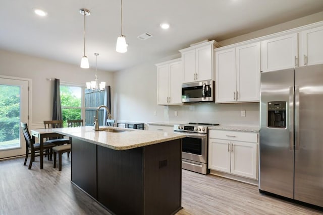 1360 Sugar Glen Ct, Lawrenceville, GA 30044 - kitchen with appliances with stainless steel finishes, a sink, a kitchen island with sink, light wood-style floors, and recessed lighting