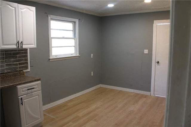 1189 Hartley St, Macon, GA 31206 - unfurnished dining area with light wood finished floors, recessed lighting, baseboards, and crown molding