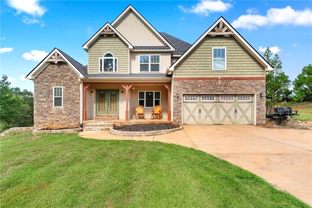 craftsman house with a front yard, a garage, and covered porch