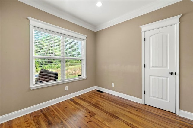 spare room featuring ornamental molding and wood-type flooring