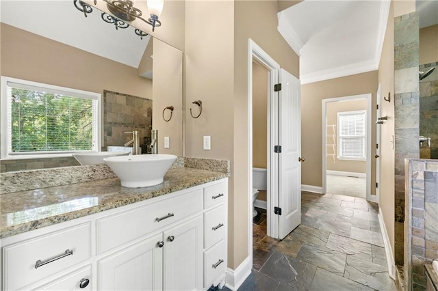 bathroom featuring walk in shower, ornamental molding, and vanity