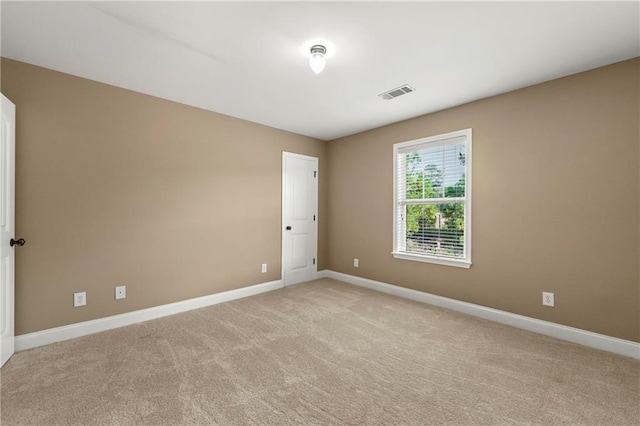 unfurnished room with light carpet