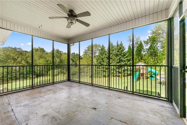 unfurnished sunroom featuring ceiling fan