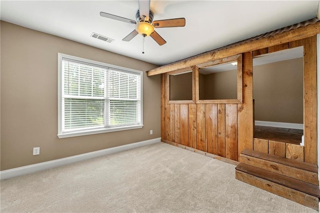 interior space with ceiling fan and light colored carpet