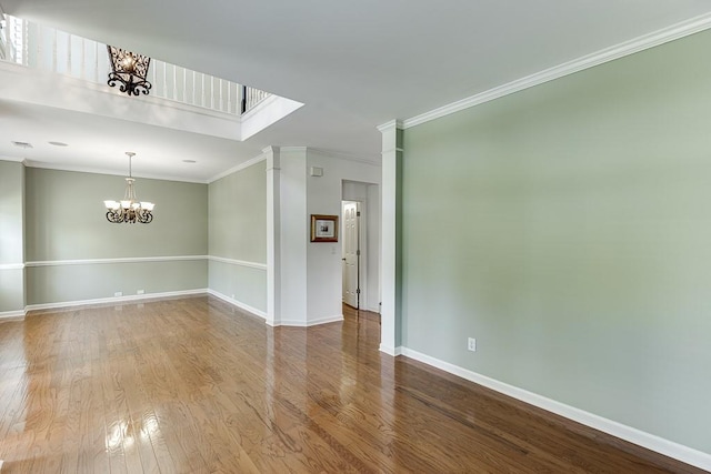 7405 Brookstone Way, Flowery Branch, GA 30542 - unfurnished room featuring a chandelier, wood finished floors, and ornamental molding