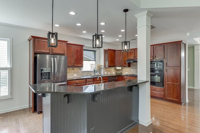 7405 Brookstone Way, Flowery Branch, GA 30542 - kitchen featuring black appliances, light wood-style flooring, tasteful backsplash, decorative columns, and a kitchen breakfast bar