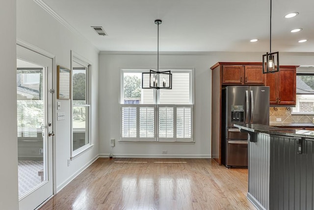 7405 Brookstone Way, Flowery Branch, GA 30542 - kitchen with stainless steel fridge with ice dispenser, light wood-style flooring, a chandelier, backsplash, and crown molding