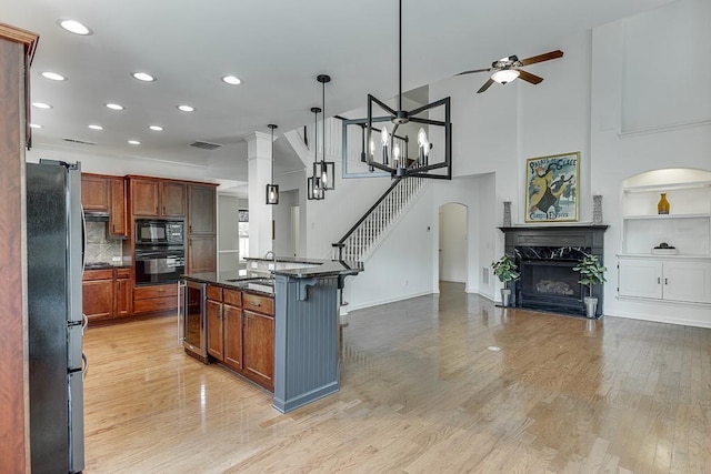 7405 Brookstone Way, Flowery Branch, GA 30542 - kitchen with black appliances, beverage cooler, open floor plan, a high end fireplace, and recessed lighting