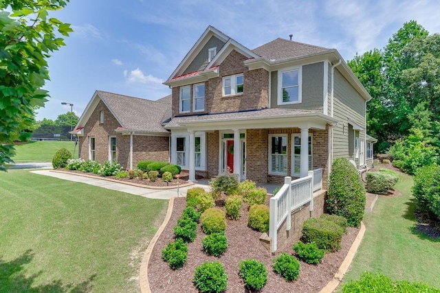 7405 Brookstone Way, Flowery Branch, GA 30542 - craftsman-style home featuring covered porch, brick siding, and a front lawn