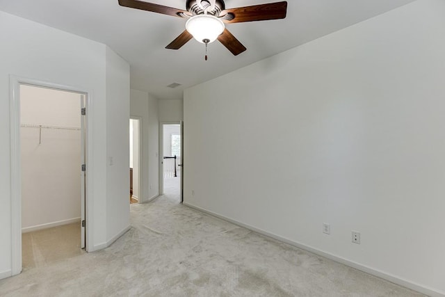 7405 Brookstone Way, Flowery Branch, GA 30542 - unfurnished bedroom with a spacious closet, light carpet, a closet, and a ceiling fan