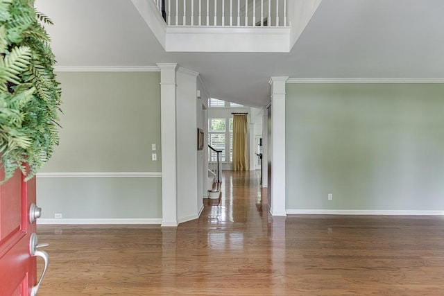 7405 Brookstone Way, Flowery Branch, GA 30542 - foyer entrance with wood finished floors, ornate columns, and ornamental molding