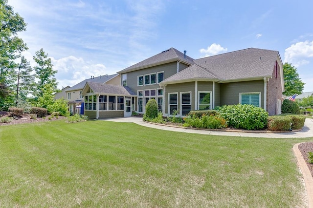 7405 Brookstone Way, Flowery Branch, GA 30542 - back of property featuring a sunroom, a lawn, and a shingled roof