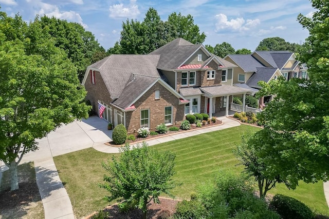 7405 Brookstone Way, Flowery Branch, GA 30542 - craftsman inspired home with driveway, brick siding, covered porch, a front yard, and a garage