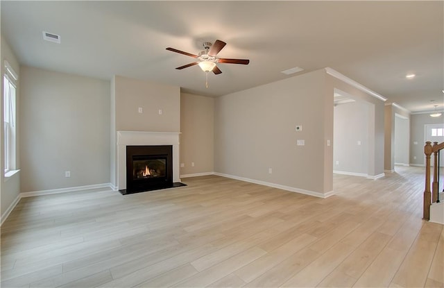251 Arnewood Cir, Mcdonough, GA 30253 - unfurnished living room with ceiling fan, light wood-style floors, and a fireplace with flush hearth