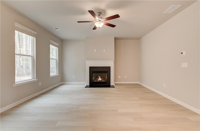 251 Arnewood Cir, Mcdonough, GA 30253 - unfurnished living room featuring ceiling fan, light wood-style floors, and a fireplace with flush hearth