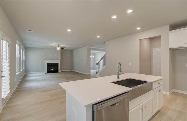 251 Arnewood Cir, Mcdonough, GA 30253 - kitchen featuring stainless steel dishwasher, ceiling fan, light wood-style floors, white cabinetry, and healthy amount of natural light