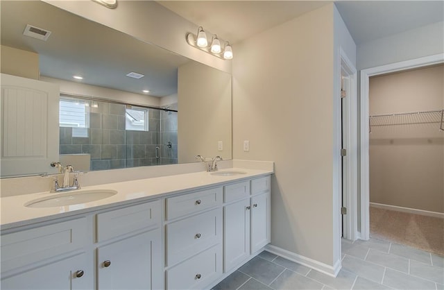 251 Arnewood Cir, Mcdonough, GA 30253 - full bath featuring double vanity, tiled shower, a walk in closet, and tile patterned floors
