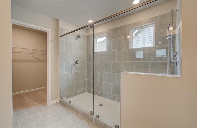 251 Arnewood Cir, Mcdonough, GA 30253 - bathroom with tile patterned flooring, a tile shower, a spacious closet, and recessed lighting