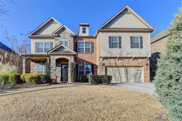 craftsman inspired home with a garage and a front yard