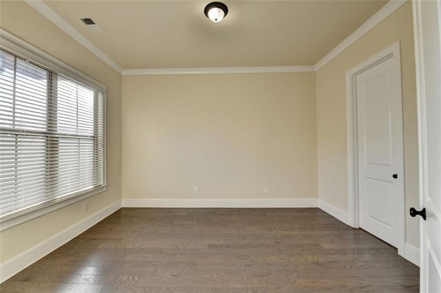 spare room with crown molding and dark hardwood / wood-style floors