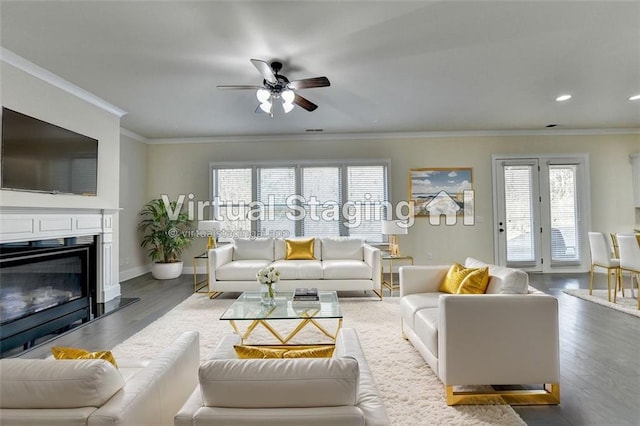 living room with hardwood / wood-style floors, crown molding, and ceiling fan