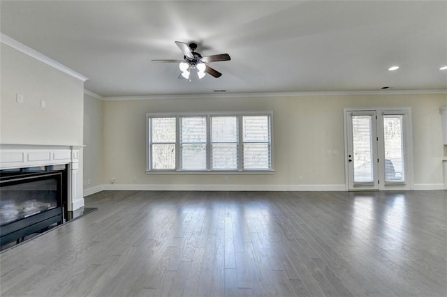 unfurnished living room with hardwood / wood-style flooring, ceiling fan, and crown molding