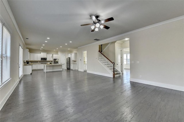 unfurnished living room featuring crown molding, ceiling fan, and dark hardwood / wood-style flooring