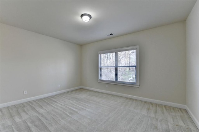 spare room featuring light colored carpet