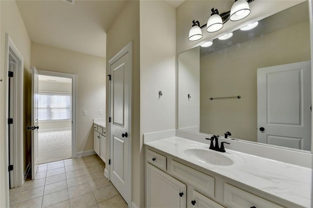 bathroom with tile patterned flooring and vanity