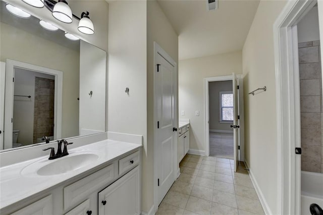 bathroom with vanity, a bath, tile patterned floors, and toilet