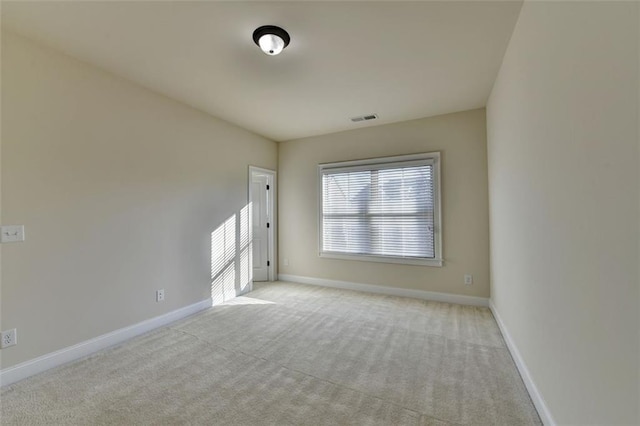 unfurnished room with light colored carpet