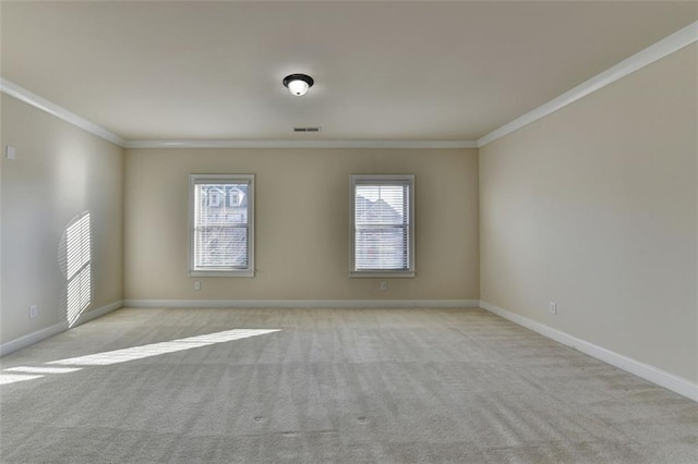 carpeted spare room featuring crown molding and a healthy amount of sunlight