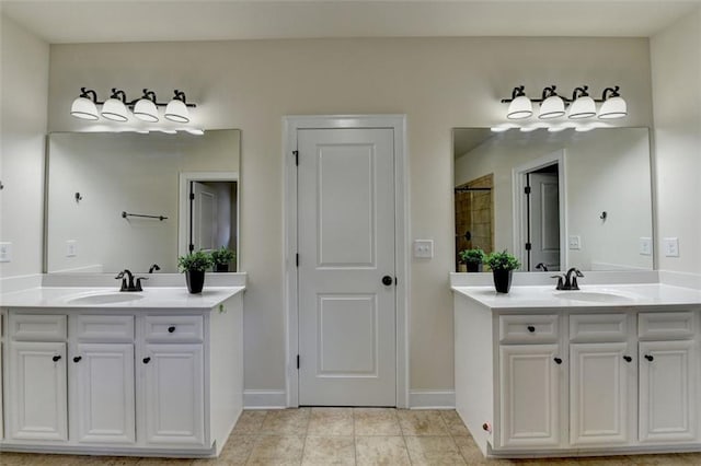 bathroom featuring vanity, a shower, and tile patterned floors