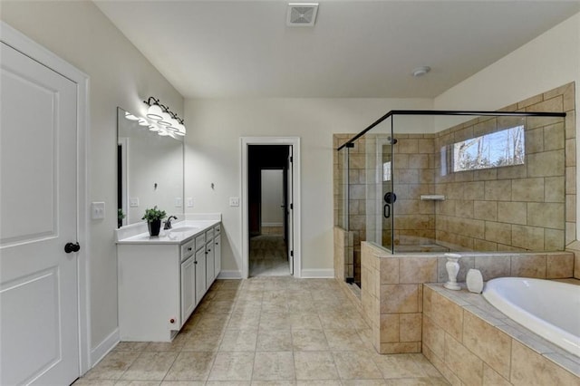 bathroom featuring tile patterned flooring, vanity, and shower with separate bathtub