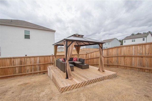 view of yard featuring a gazebo, a fenced backyard, outdoor lounge area, and a wooden deck