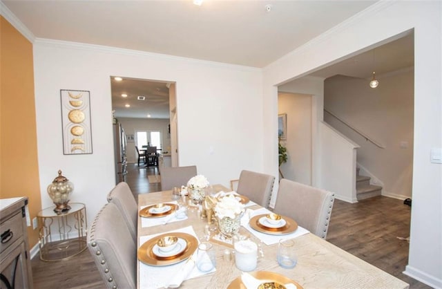 dining area with baseboards, ornamental molding, stairs, and wood finished floors