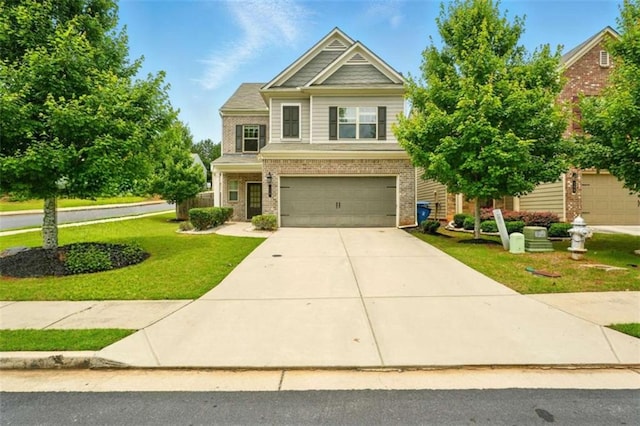 119 Hardy Water Dr, Lawrenceville, GA 30045 - craftsman-style house with brick siding, a front lawn, an attached garage, and driveway