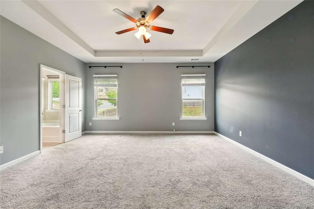 119 Hardy Water Dr, Lawrenceville, GA 30045 - empty room featuring a tray ceiling, carpet, ceiling fan, and baseboards