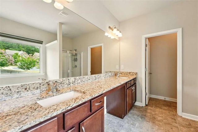 119 Hardy Water Dr, Lawrenceville, GA 30045 - bathroom with double vanity, a shower stall, and baseboards
