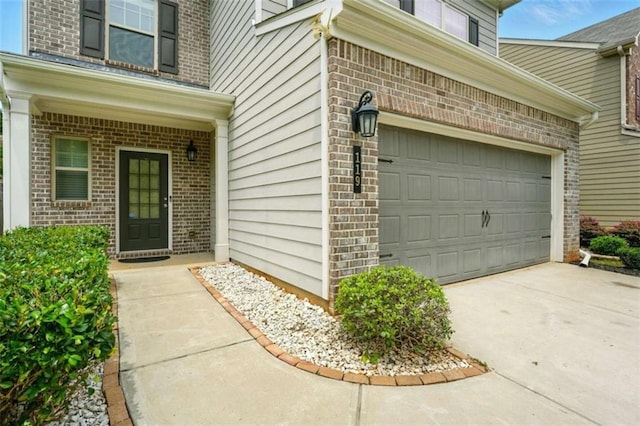 119 Hardy Water Dr, Lawrenceville, GA 30045 - property entrance featuring brick siding, driveway, and a garage